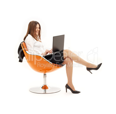 businesswoman with laptop in orange chair