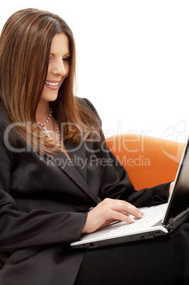 portrait of businesswoman with laptop in orange chair