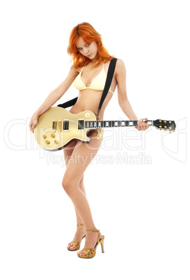 redhead with golden guitar on high heels