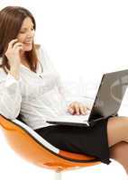 businesswoman with laptop and phone in orange chair