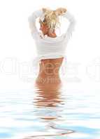 lovely blond in water pulling hair up