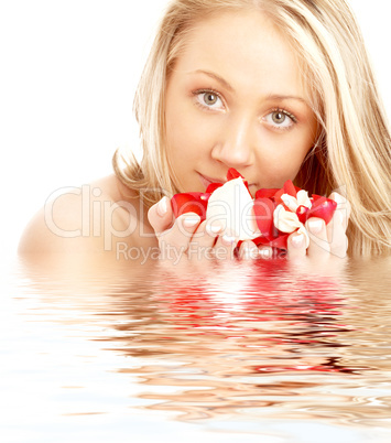 happy blond in water with red and white petals