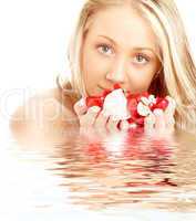 happy blond in water with red and white petals