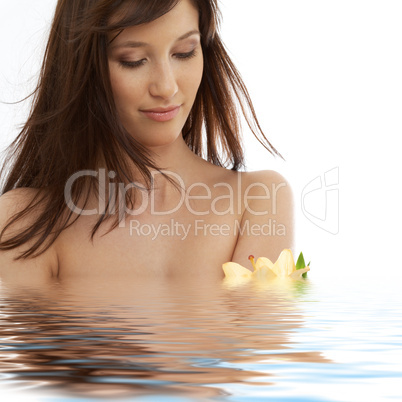 brunette with yellow lily flowers in water