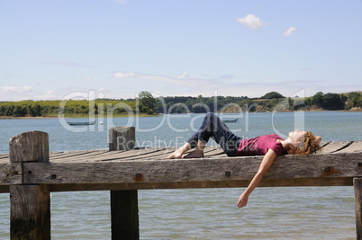 Girl relaxing at landing stage in France