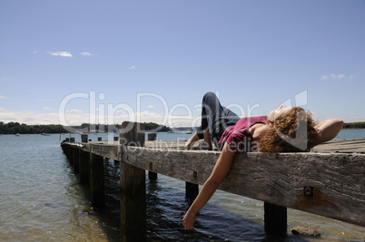 Girl relaxing on landing stage