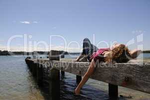 Girl relaxing on landing stage