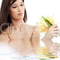 happy brunette with yellow lily flowers in water #2