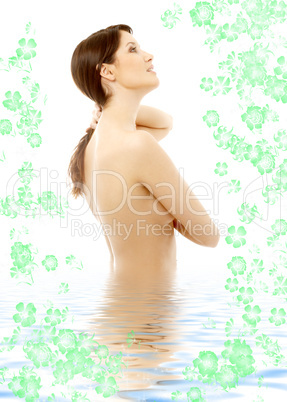 topless brunette in water with flowers looking up #2