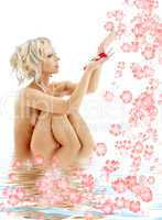 naked blond with rose petals and flowers in water