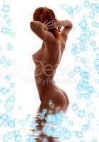 redhead nude in water with flowers