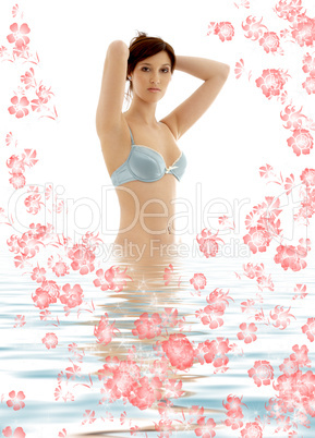 brunette in blue lingerie standing in water with flowers #3