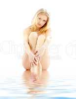 blond washing feet in water