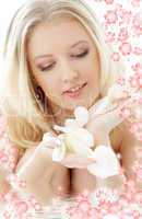 lovely blond with white rose petals and flowers in water