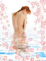 healthy redhead in blue water with flowers