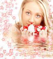 happy blond in water with red and white flowers