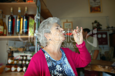 Senior woman drinking alcohol