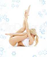 blond in white underwear practicing yoga with snowflakes
