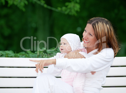 happy mother with baby on the bench