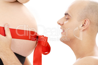 proud father and belly with red ribbon