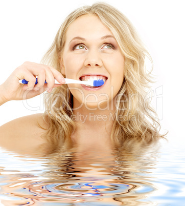 happy blond with toothbrush in water