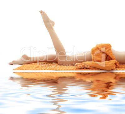 long legs of girl with orange towel on white sand #2