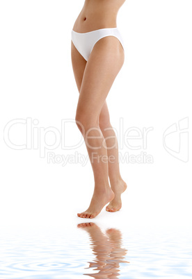 long legs in bikini panties on white sand