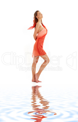 girl with red sarong on white sand