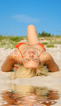 tanning woman on sand