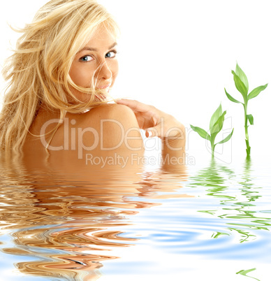 happy blonde in water with green plants