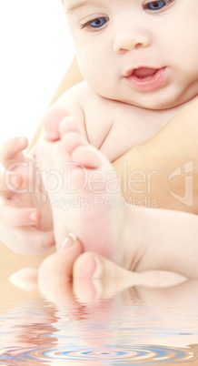 bathing baby in mother hands