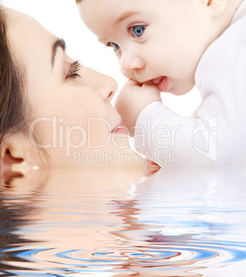 happy mother playing with baby boy in water #2