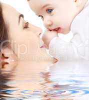 happy mother playing with baby boy in water #2