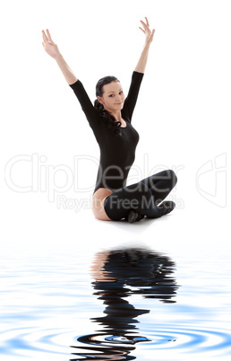 fitness in black leotard on white sand