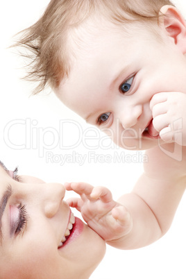 happy blue-eyed baby boy touching mama