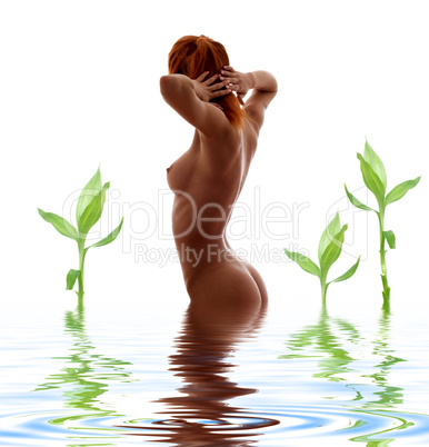 redhead nude in water with green plants
