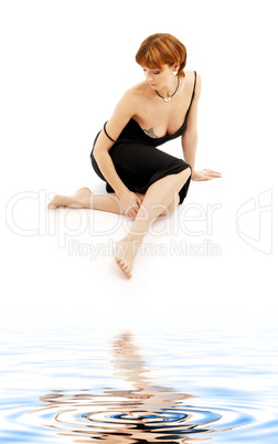 relaxed lady in black dress on white sand