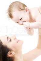 laughing blue-eyed baby playing with mom