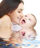 playful mama with happy baby in water