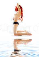 kneeled redhead in black panties on white sand