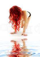 creeping redhead lady on white sand