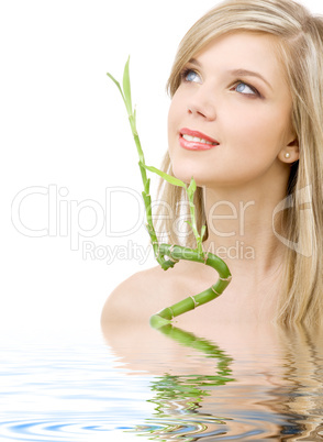 blue-eyed blonde with bamboo in water