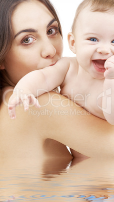 baby boy and beautiful mama in water