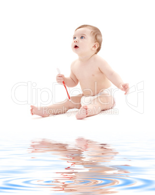 baby boy in diaper with toothbrush