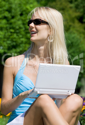 outdoor picture of lovely blonde with laptop