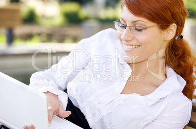 smiling businesswoman with laptop computer