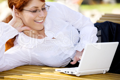 businesswoman with laptop in the park