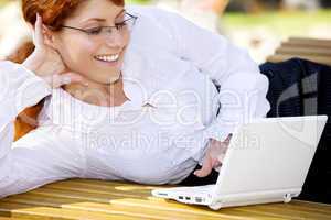 businesswoman with laptop in the park