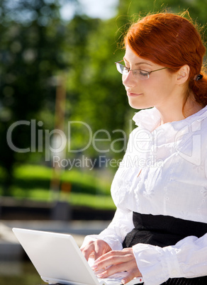 businesswoman with laptop in the park