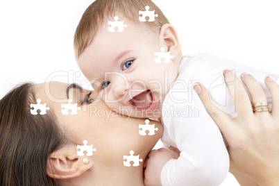 puzzle of laughing baby playing with mother